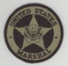 The US Marshals Service badge (subdued).